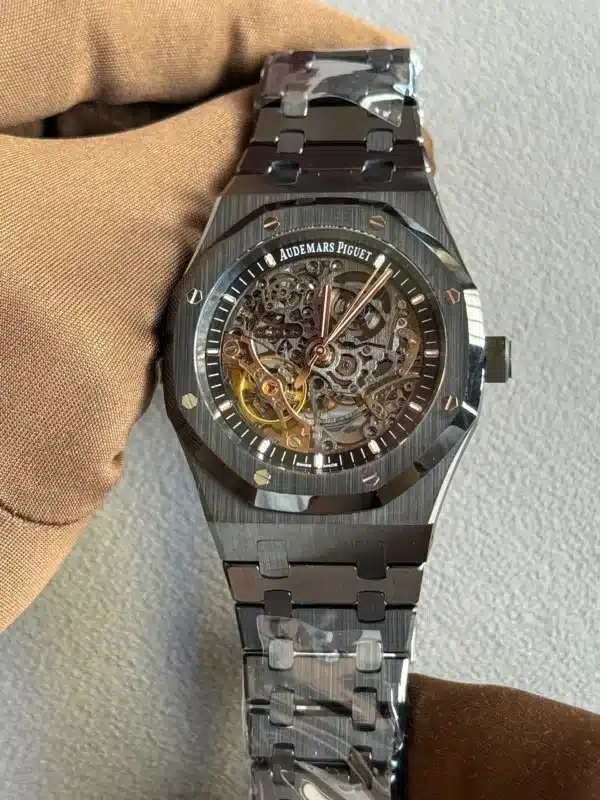 Skeleton-style Audemars Piguet wristwatch with visible gears through a transparent dial on a metal bracelet