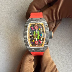 IMG_6651 - Ticker24Watches Ticker24Watches - Skeleton dial Richard Mille wristwatch with orange strap worn on a gloved hand, showing colorful inner gears.