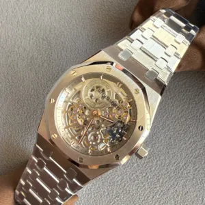 Close-up of a skeleton-dial luxury watch with a silver metal bracelet on a brown glove, showing exposed gears and screws on the bezel.