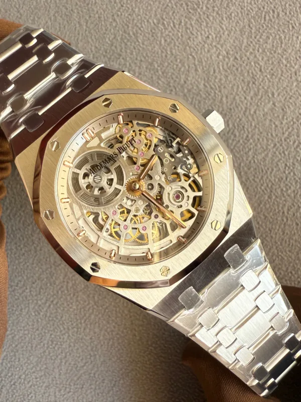 Skeleton wristwatch with exposed gold gears inside a brushed gold case and octagonal bezel with screws; Audemars Piguet logo visible on the movement edge.